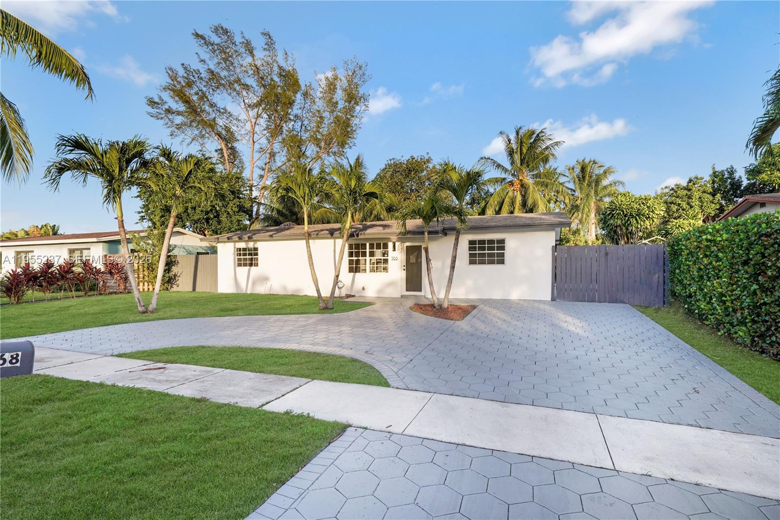 368 Southwest 64th Terrace Pompano Beach, FL 33068 - Photo 2 of 23 a view of a house with a yard and potted plants