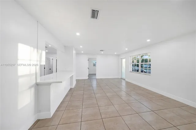 a view of an empty room and a window