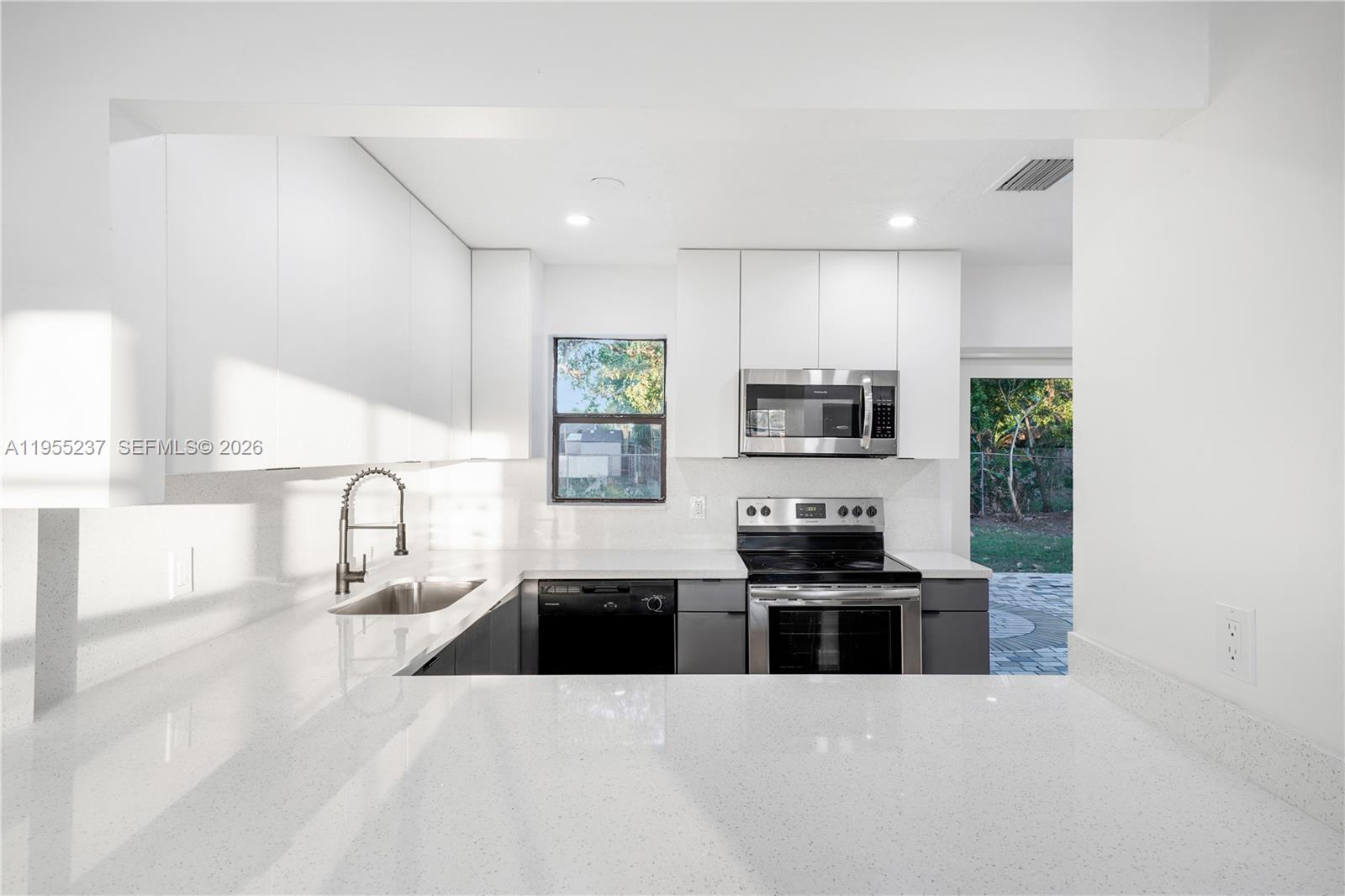 368 Southwest 64th Terrace Pompano Beach, FL 33068 - Photo 7 of 23 a kitchen with granite countertop a stove and a sink