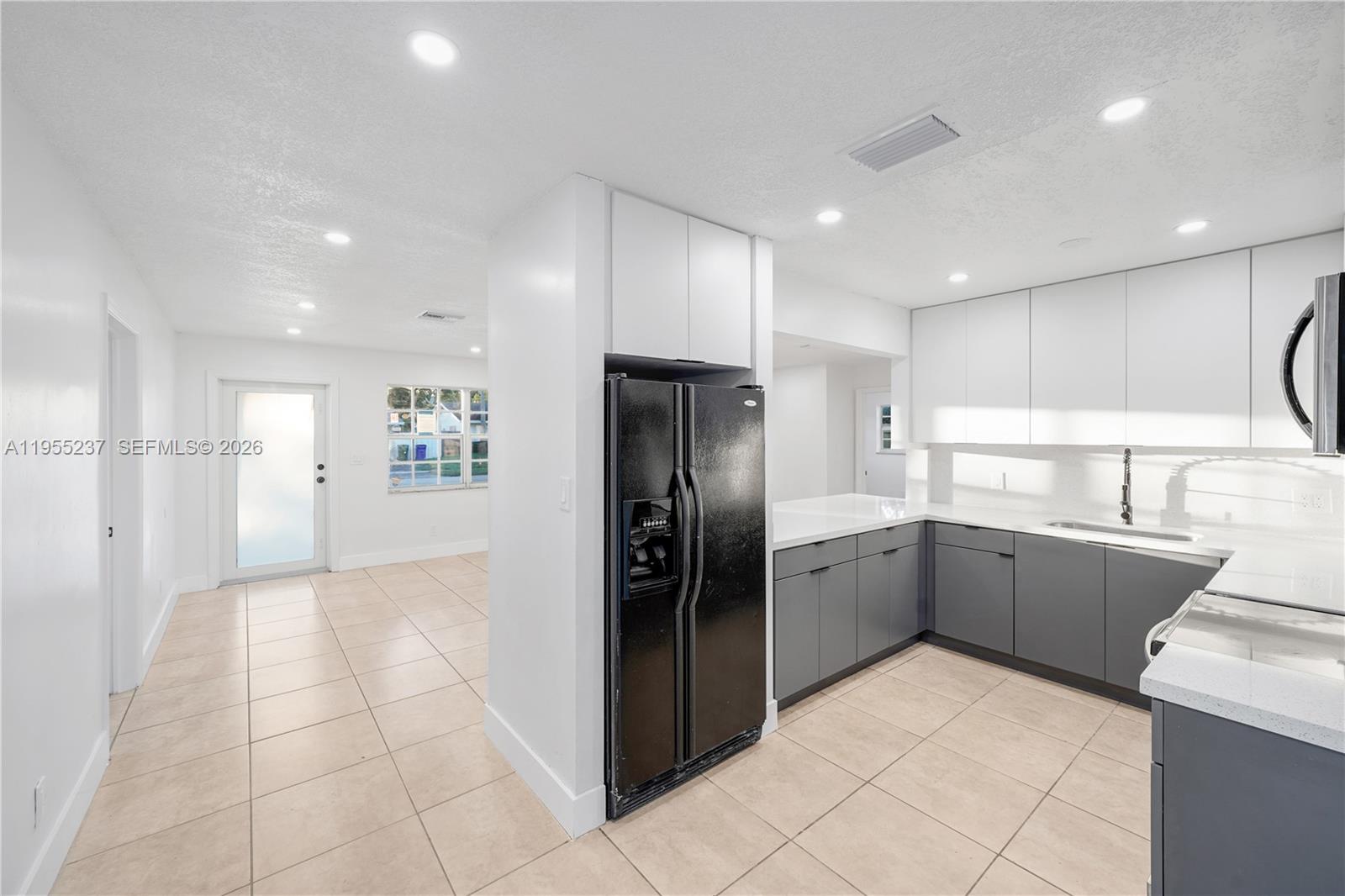 368 Southwest 64th Terrace Pompano Beach, FL 33068 - Photo 8 of 23 a kitchen with a refrigerator and a sink