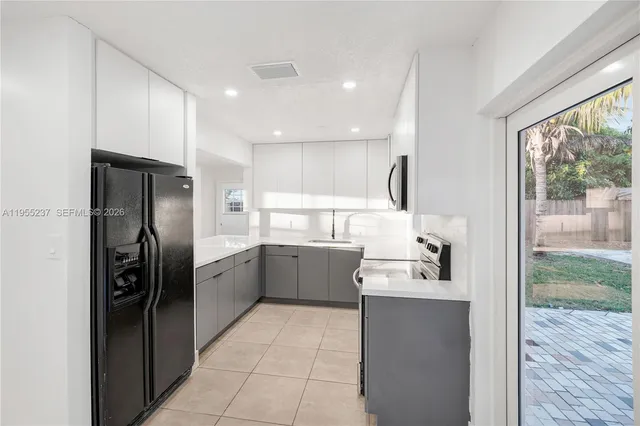 a kitchen with a refrigerator and a sink