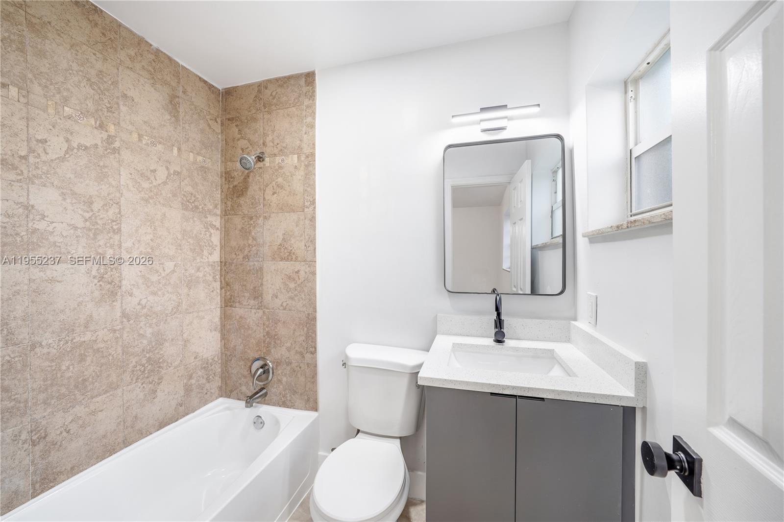 368 Southwest 64th Terrace Pompano Beach, FL 33068 - Photo 10 of 23 a bathroom with a sink vanity mirror and toilet