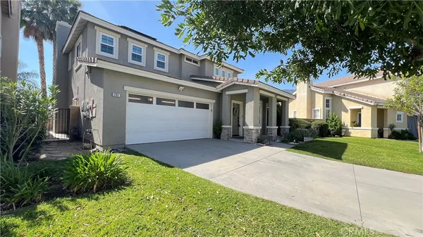 a front view of a house with a yard and garage