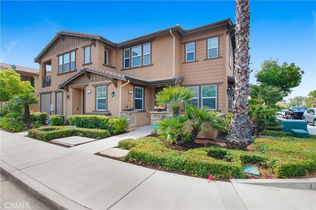 16001 Chase Road, Unit 68 Fontana, CA 92336 - Photo 1 of 1 a front view of a house with a yard