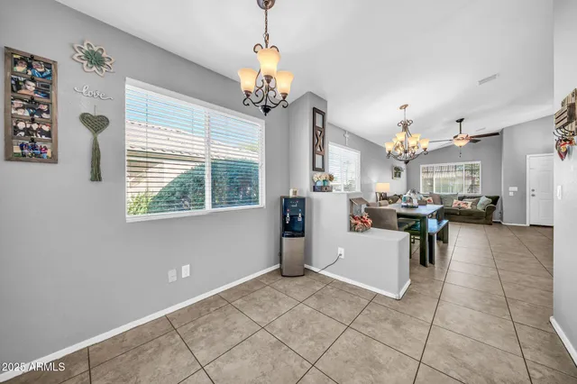 a living room with patio furniture and a chandelier