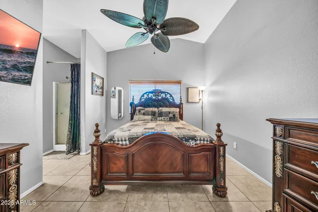 a bedroom with a bed and a chandelier