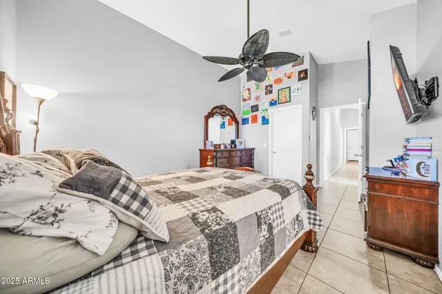 a spacious bedroom with a bed and a dresser