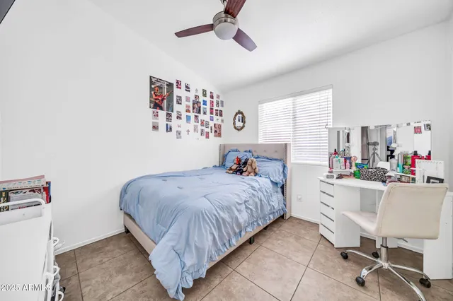 a bedroom with a bed and a desk