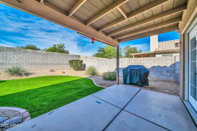 a view of a backyard with plants and a patio