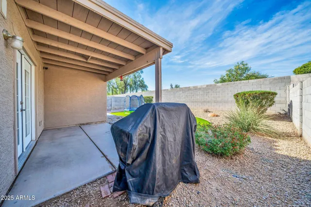 a view of a backyard with plants and outdoor seating