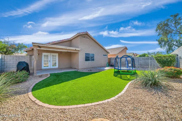 a view of a house with a backyard