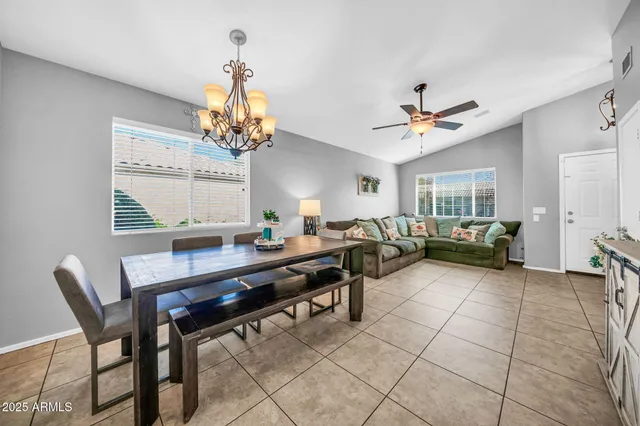 a living room with furniture a chandelier and a window