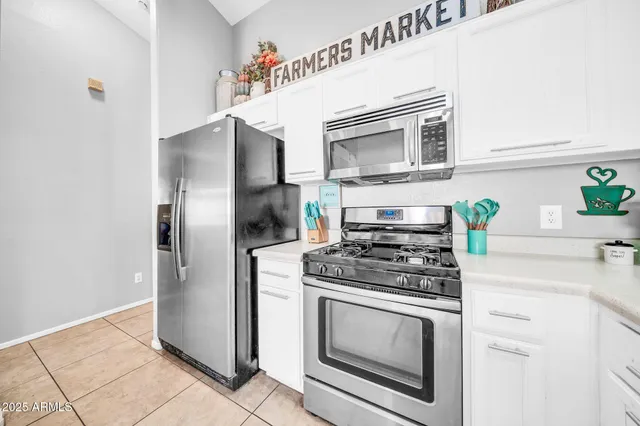 a kitchen with stainless steel appliances granite countertop a stove and a refrigerator