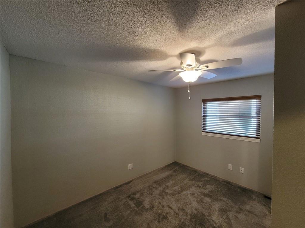 212 Summit Street Butler, PA 16001 - Photo 9 of 17 an empty room with a chandelier fan and windows