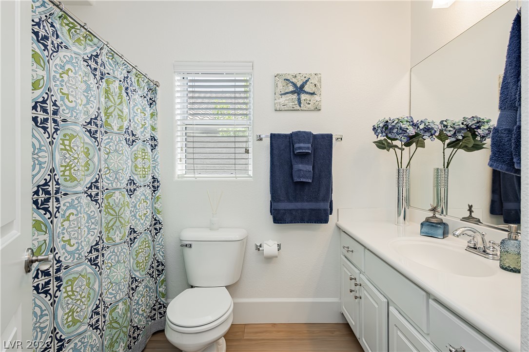 2256 Dogwood Ranch Avenue Henderson, NV 89052 - Photo 30 of 51 A pristine bathroom features a vanity with ample storage and a window with natural illumination.