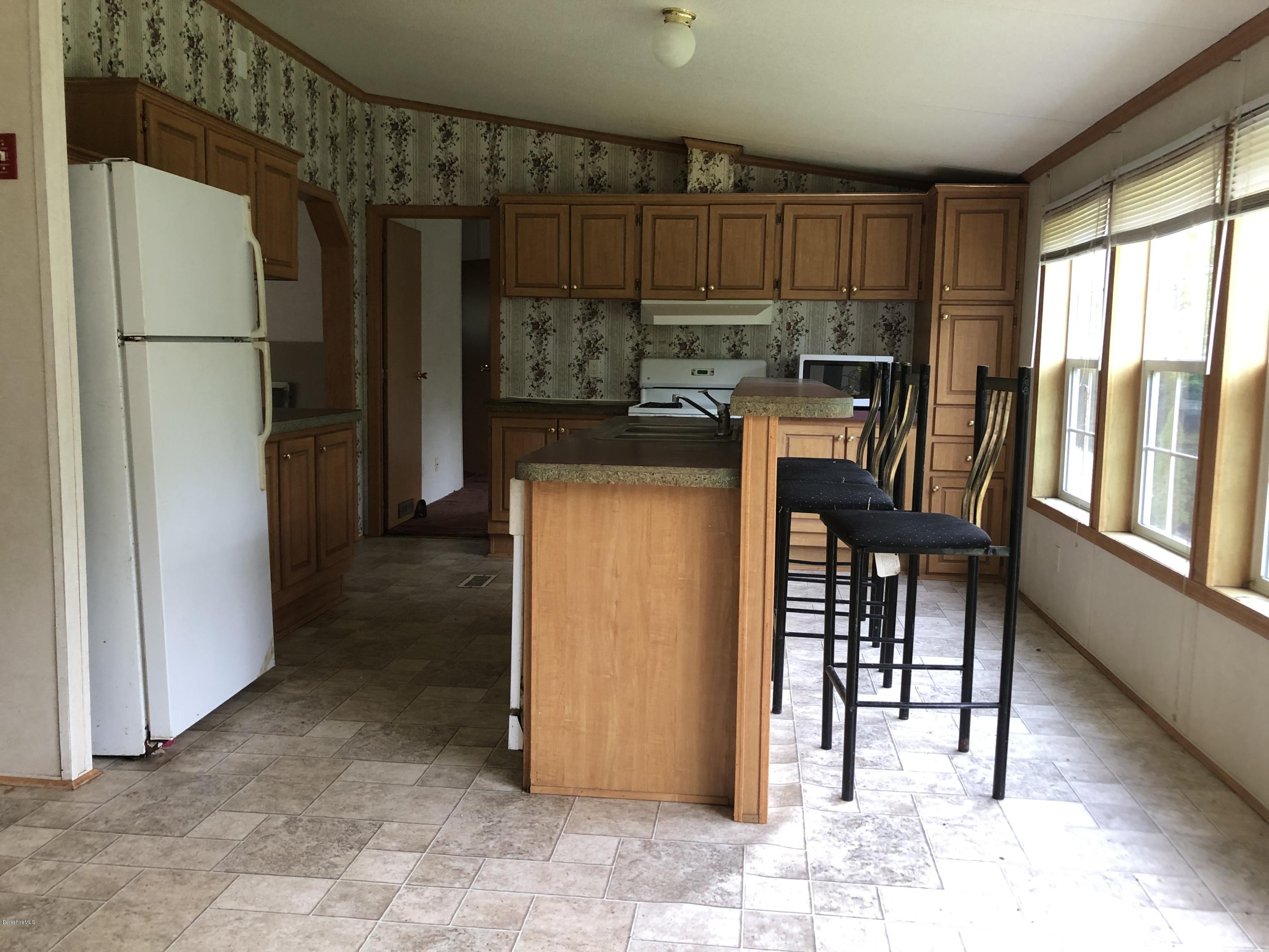 55 East Windsor Road Peru, MA 01235 - Photo 7 of 28 a kitchen with refrigerator and cabinets