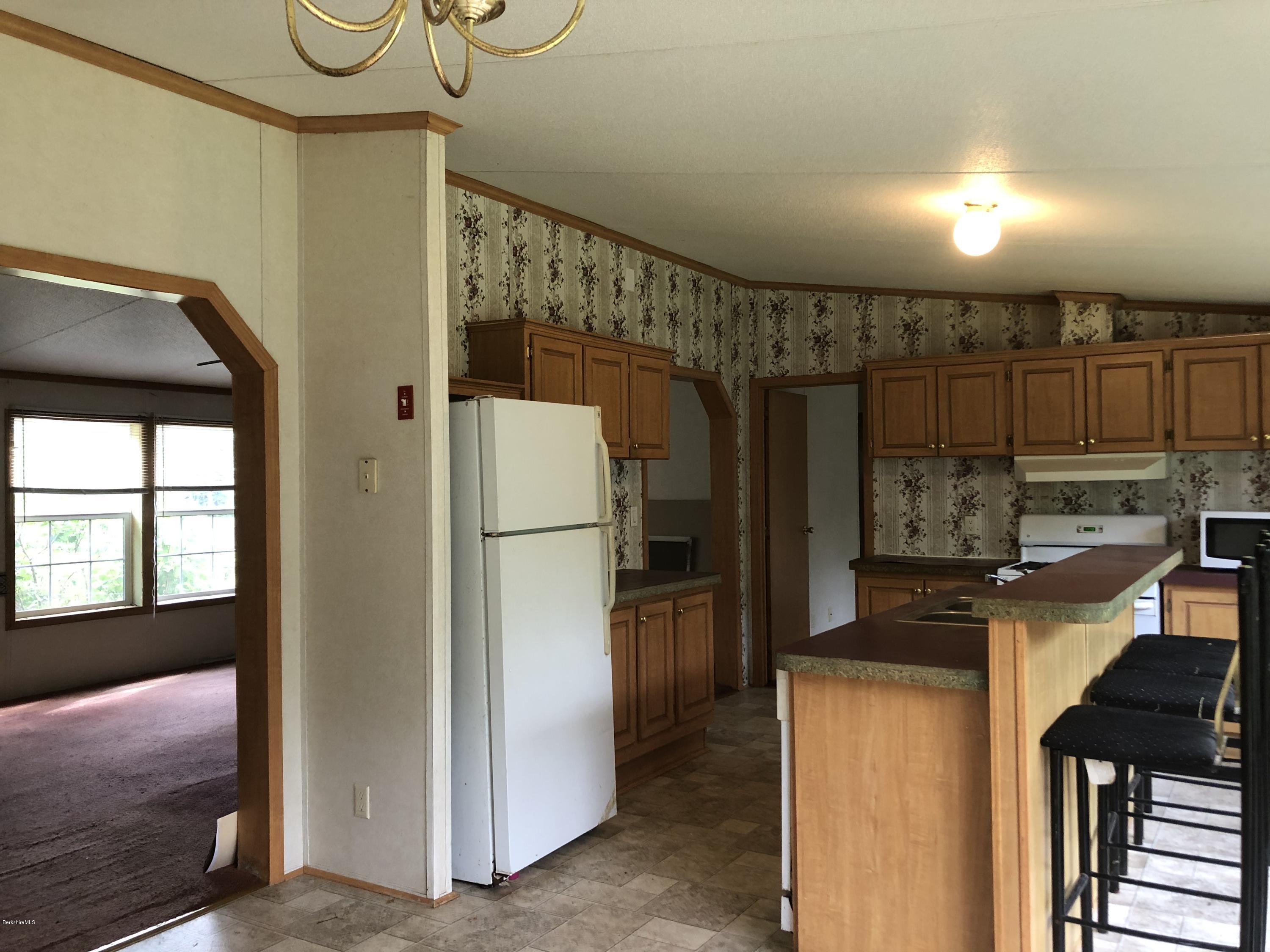 55 East Windsor Road Peru, MA 01235 - Photo 9 of 28 a kitchen with refrigerator a washer and dryer