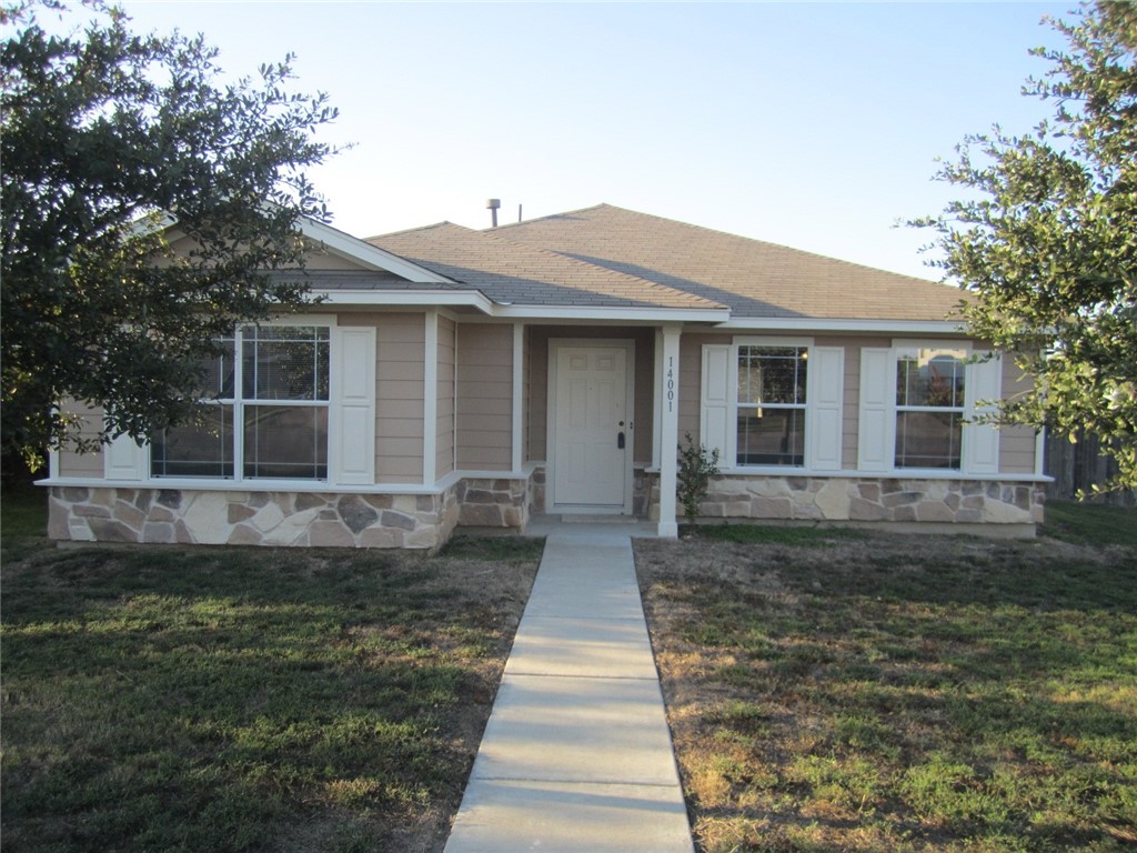 14001 Briarcreek Loop Manor, TX 78653 - Photo 1 of 1 a front view of a house with yard
