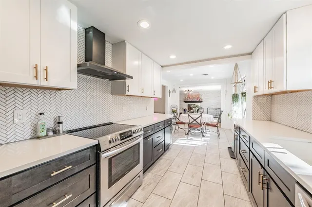 a kitchen with a sink stove and cabinets