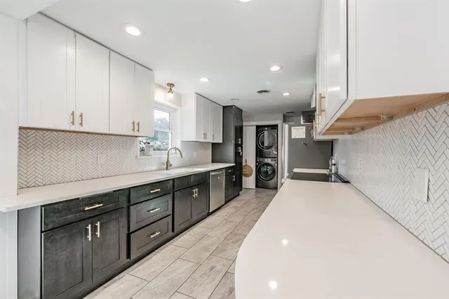 a kitchen with stainless steel appliances kitchen island granite countertop a sink and cabinets