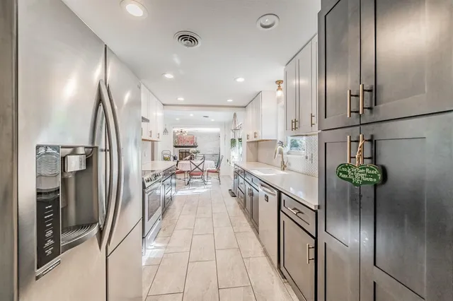 a kitchen with stainless steel appliances lots of counter top space