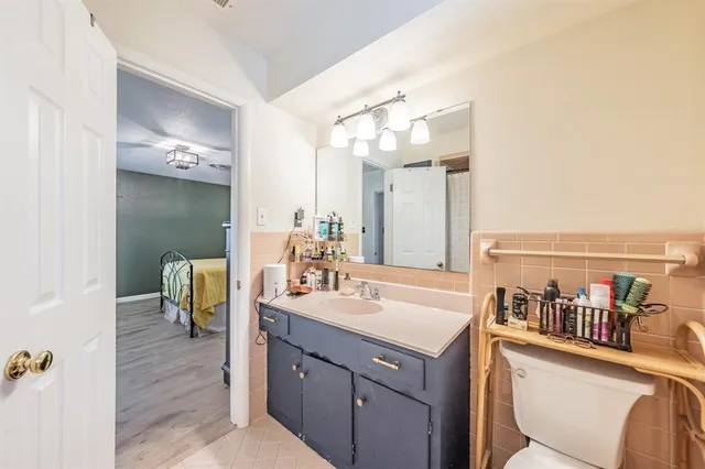 a bathroom with a sink vanity granite and a mirror