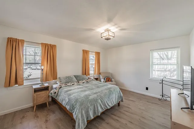 a spacious bedroom with a bed and a window