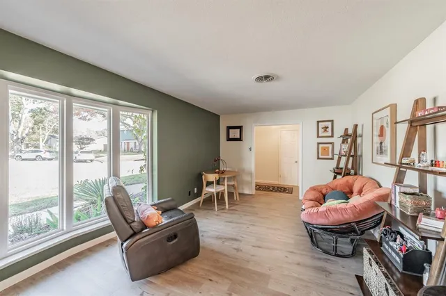 a living room with furniture a table and a large window