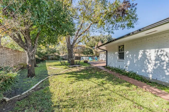 a view of backyard of house with green space