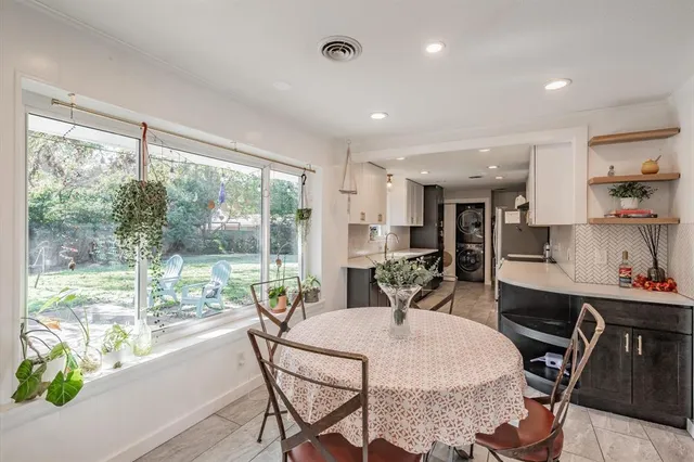 a kitchen with a table and chairs in it