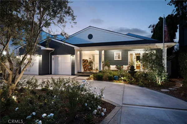 a large tree in front of a house