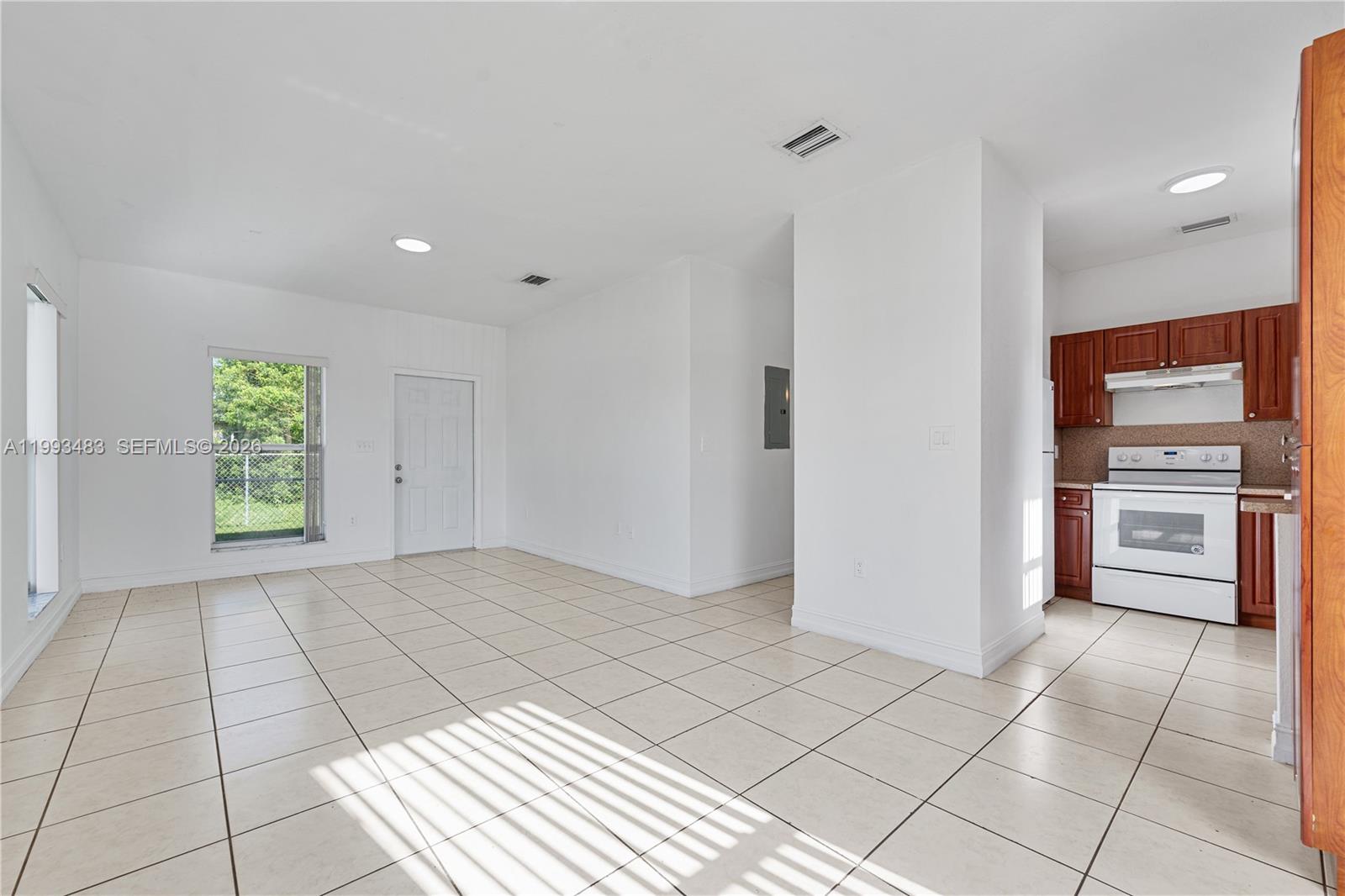 10357 Southwest 178th Street, Unit 10357 Miami, FL 33157 - Photo 12 of 25 a view of a kitchen with a sink and an empty room