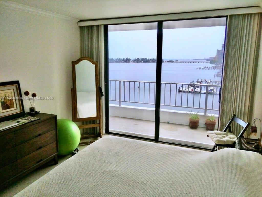 200 Southeast 15th Road, Unit 9B Miami, FL 33129 - Photo 11 of 39 a bedroom with furniture and a window
