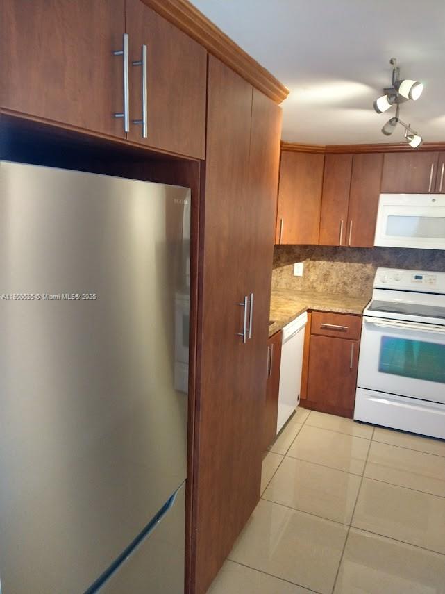 200 Southeast 15th Road, Unit 9B Miami, FL 33129 - Photo 19 of 39 a kitchen with stainless steel appliances a refrigerator and cabinets