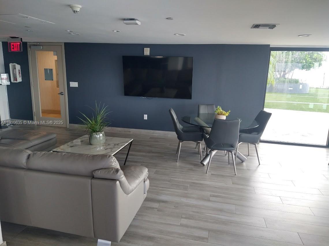 200 Southeast 15th Road, Unit 9B Miami, FL 33129 - Photo 25 of 39 a living room with furniture and a flat screen tv