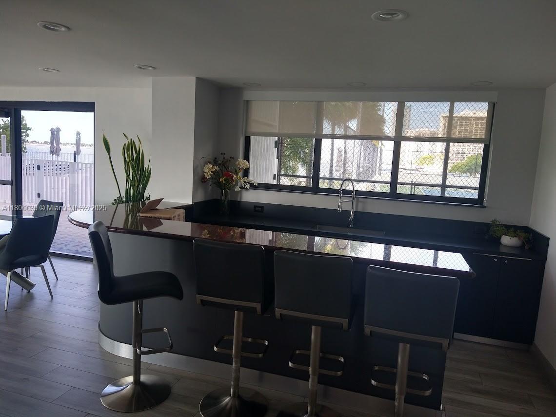 200 Southeast 15th Road, Unit 9B Miami, FL 33129 - Photo 29 of 39 a dining room with furniture and wooden floor