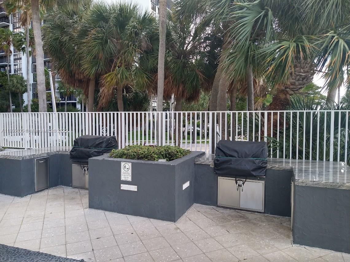 200 Southeast 15th Road, Unit 9B Miami, FL 33129 - Photo 32 of 39 a view of a chair and tables in the patio