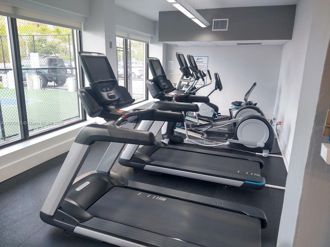 200 Southeast 15th Road, Unit 9B Miami, FL 33129 - Photo 34 of 39 a view of gym equipment with a floor to ceiling window