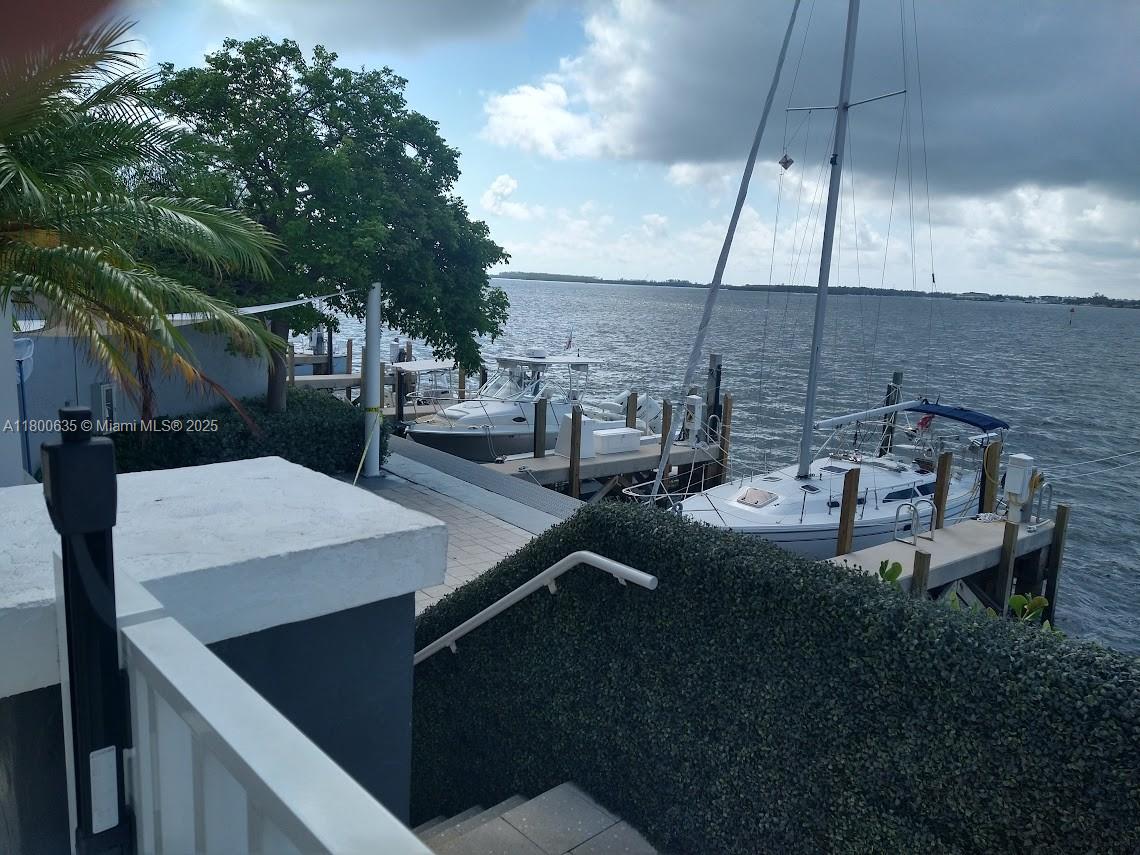 200 Southeast 15th Road, Unit 9B Miami, FL 33129 - Photo 36 of 39 a view of a patio with table and chairs under an umbrella