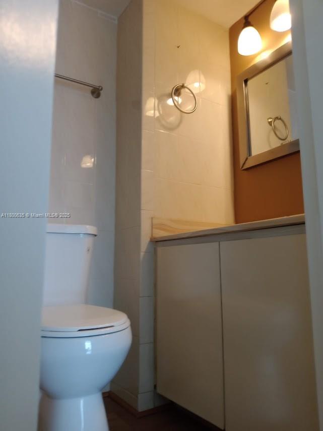 200 Southeast 15th Road, Unit 9B Miami, FL 33129 - Photo 7 of 39 a bathroom with a toilet a sink and mirror