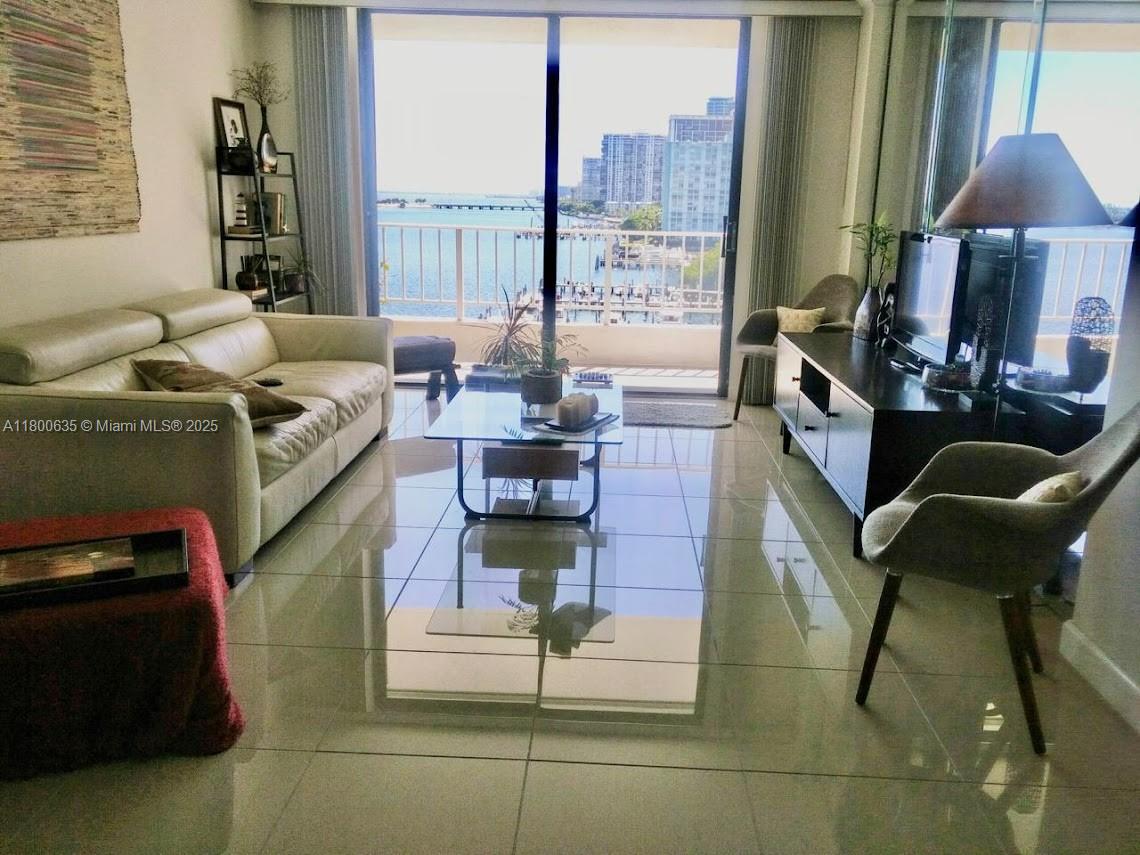 200 Southeast 15th Road, Unit 9B Miami, FL 33129 - Photo 10 of 39 a living room with furniture and a lamp