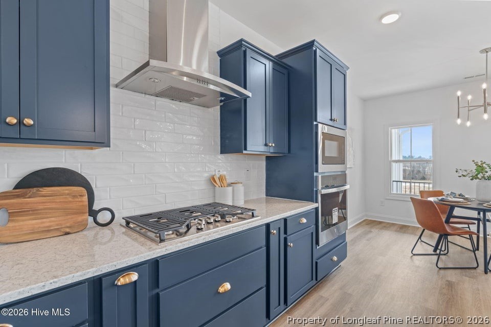 515 Sanctuary Trail Cameron, NC 28326 - Photo 22 of 46 a kitchen with a stove a sink and a refrigerator