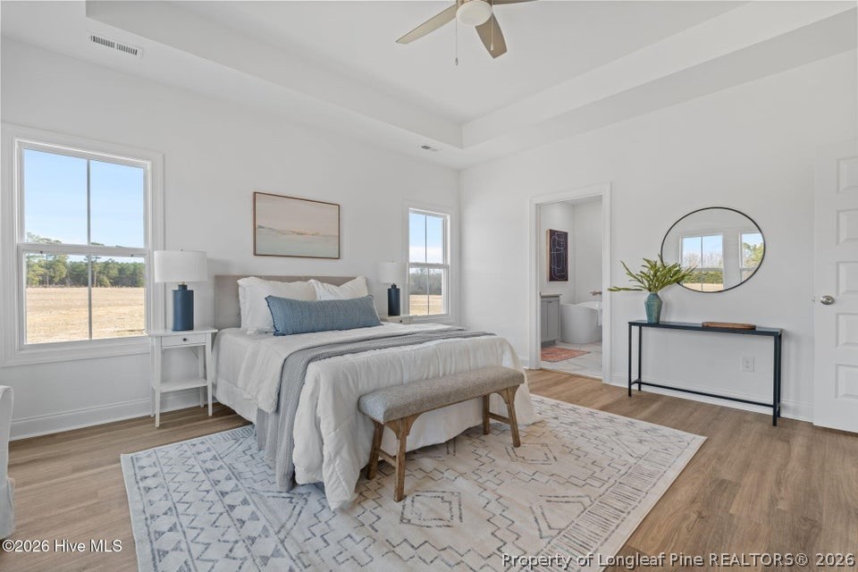 515 Sanctuary Trail Cameron, NC 28326 - Photo 29 of 46 a bedroom with a bed mirror and window