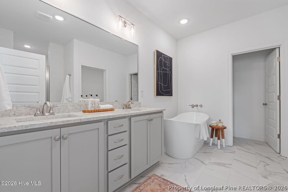 515 Sanctuary Trail Cameron, NC 28326 - Photo 30 of 46 a bathroom with a double vanity sink mirror and bathtub