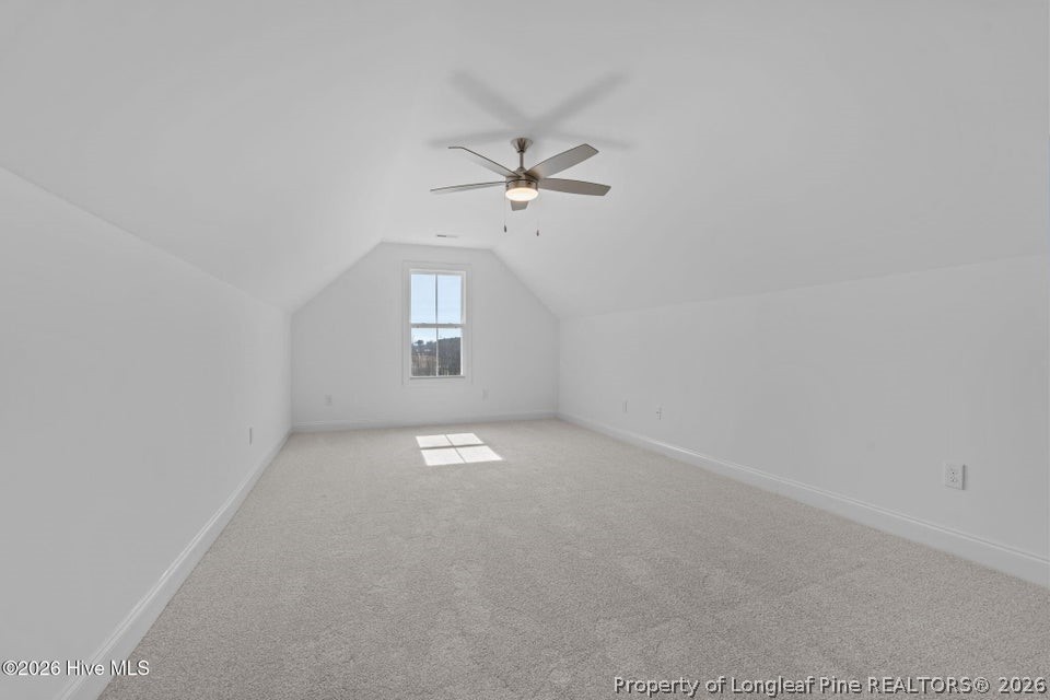515 Sanctuary Trail Cameron, NC 28326 - Photo 37 of 46 an empty room with a chandelier fan and windows
