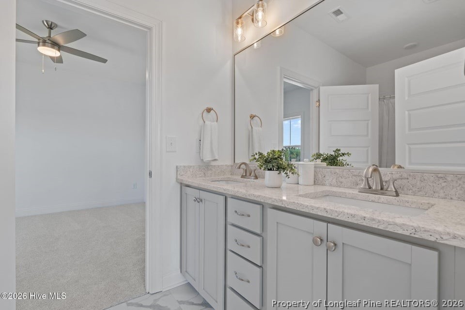 515 Sanctuary Trail Cameron, NC 28326 - Photo 40 of 46 a bathroom with a granite countertop sink and a mirror