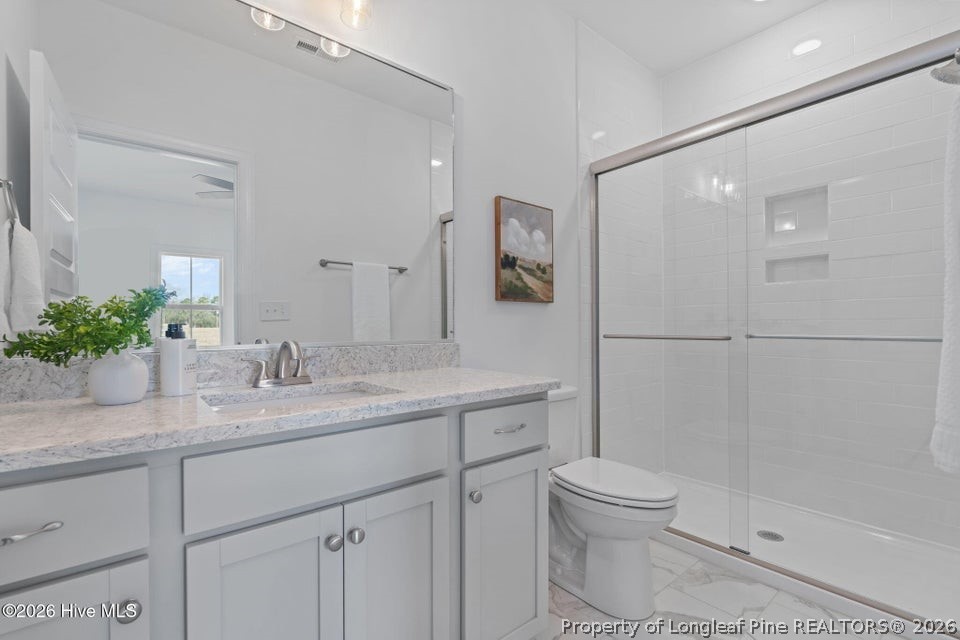 515 Sanctuary Trail Cameron, NC 28326 - Photo 43 of 46 a bathroom with a granite countertop sink a toilet and shower