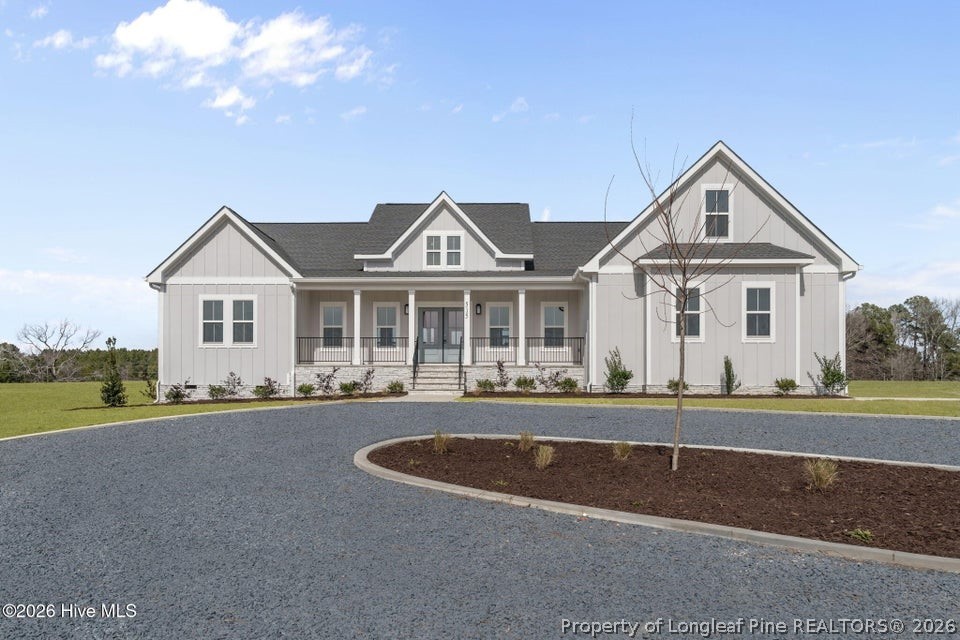 515 Sanctuary Trail Cameron, NC 28326 - Photo 11 of 46 a front view of a house with a yard and garage