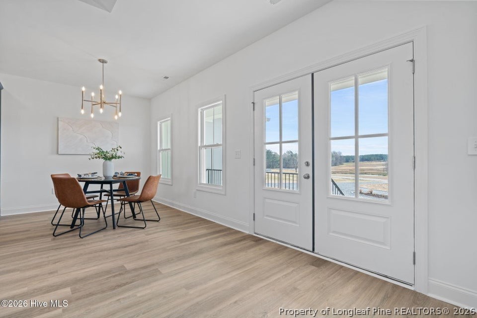 515 Sanctuary Trail Cameron, NC 28326 - Photo 14 of 46 a dining room with furniture a chandelier and wooden floor