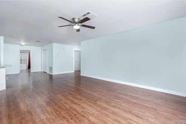 a view of a livingroom with a hardwood floor and a ceiling fan